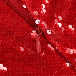 Macro view of high-density red sequins and matching invisible zipper on sequin dress