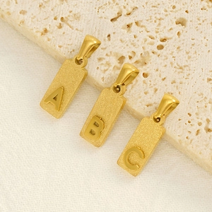 Golden titanium steel alphabet pendant necklace with matte sandblasted finish on stone