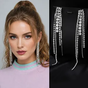 Close-up of sparkling silver tassel earrings with multiple rows of pavé set zircons
