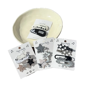 Set of music-themed hair clips with piano keys, stars and notes in black and white