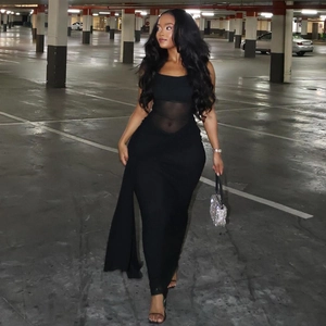 Detailed view of the mesh sheer paneling on this slim fit black maxi dress waist