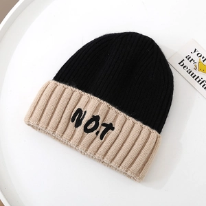 Close-up of knit texture and NOT embroidery on two-tone winter beanie cap