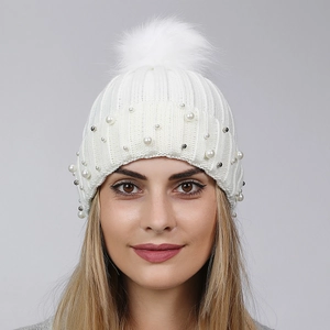 White winter knit hat for women with fluffy faux fur pom and elegant pearl beads decoration
