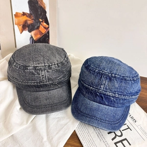 Retro washed denim cadet caps in black and blue shown on a minimalist white backdrop