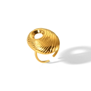 Detailed view of a gold spiral textured adjustable ring with a unique shell design