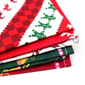 Stack of festive Christmas dog bandanas with reindeer, gingerbread and plaid patterns