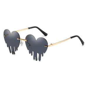 Trendsetting teardrop shaped heart sunglasses with grey ocean lenses and gold metal frames
