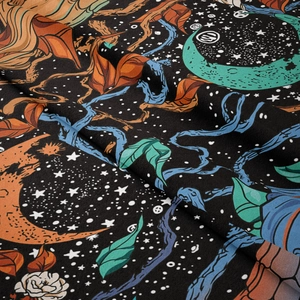 Close-up of bohemian tapestry fabric showing fine woven texture and moon floral pattern