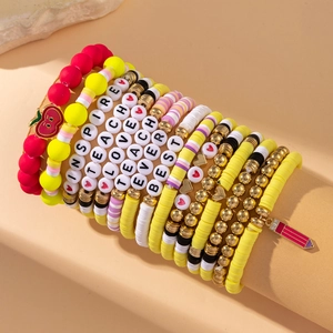 Colorful beaded bracelet set with teacher-themed apple pendants and inspire lettering
