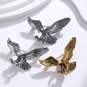 Vintage eagle brooches set in antique silver, gun black and gold finish with red eyes
