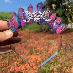 Detail of handmade iridescent purple crystal crown with silver moon phase metal accents