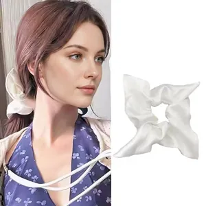 Classic glossy white satin oversized scrunchie hair tie shown in a lifestyle model view