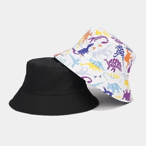 Detail of reversible fisherman hat set featuring black canvas and dinosaur patterns