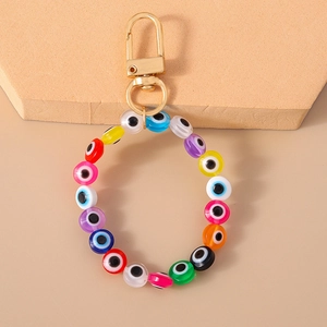 Detail of colorful evil eye beaded keychain bracelet with golden metal spring clasp