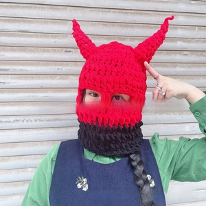 Close-up of thick knit devil horn balaclava mask with textured red and black stitching
