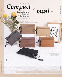 Detail showing various colors of small canvas coin purses with metal key ring hooks