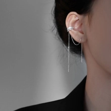 Detailed view of silver bow-shaped tassel ear cuff chain earrings for women