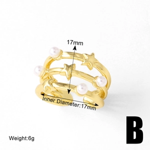 Close-up of gold-plated triple layer ring with pearl and star details showing 17mm diameter