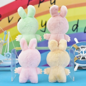 Vista posteriore dettagliata di quattro portachiavi a forma di coniglio in peluche colorati