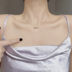Minimalist 925 sterling silver wavy bar necklace on model with elegant satin top
