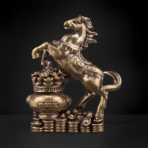 Detail of brass horse statue on treasure bowl base with coins and golden ingots