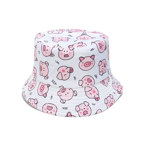 Detailed view of white bucket hat with cute pink pig print and durable stitched brim