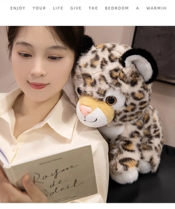 Close-up of soft plush leopard toy featuring realistic spots and large round eyes