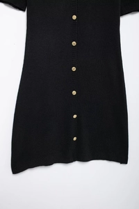 Detail of the knit texture and golden buttons on this elegant black knitted dress