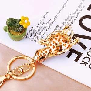 Detailed underside of golden turtle keychain showing honeycomb hollow metal craftsmanship