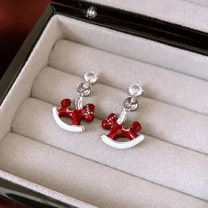 Exquisite silver needle rocking horse earrings with red enamel and zircon accents