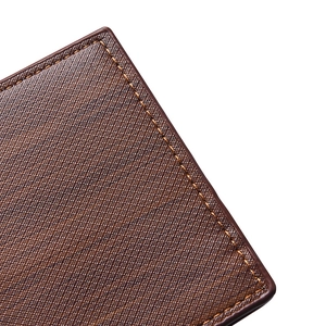 Close-up of brown leather wallet featuring cross-grain texture and detailed stitching