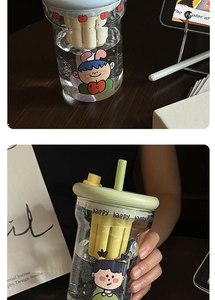 Detail view of the glass tea tumbler featuring a removable strainer and cute cartoon patterns