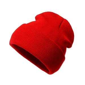 Detail view of red knitted beanie featuring premium ribbed texture and folded cuff design