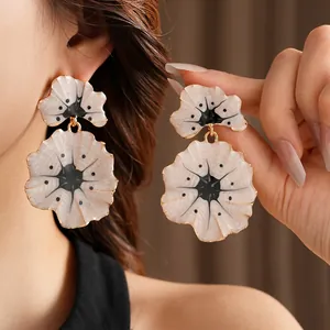Vintage enamel ginkgo flower drop earrings in gold and white with radial star pattern