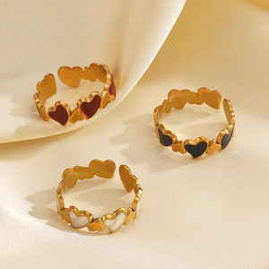 Three-piece gold plated stainless steel heart rings with colorful inlay in red black and white