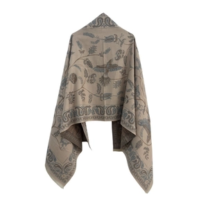 Close-up of soft woven shawl with detailed navy blue paisley and floral patterns