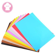 Detailed stack of multi-colored rectangular silicone mats for kitchen and dining use