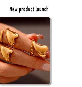 Close-up of elegant 18k gold plated stainless steel intertwined heart rings on a finger