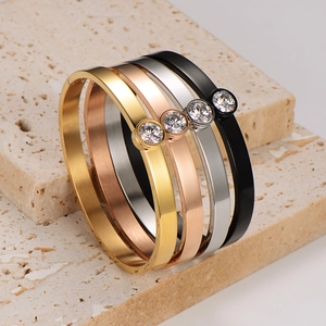 Polished stainless steel bangle set with single zircon in gold, rose gold, silver and black