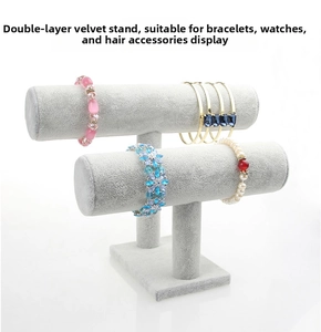 Gray velvet two-tier T-bar jewelry display stand showcasing assorted bracelets and bangles