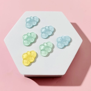Colorful ice-clear resin cloud accessories in blue, green, and yellow for DIY crafts