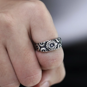 Macro view of industrial punk gear texture on vintage stainless steel ring with black finish