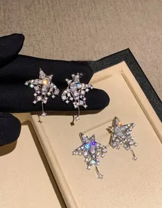 Macro view of sterling silver star tassel earrings with shimmering cubic zirconia