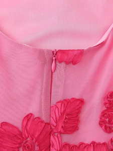 Close-up of pink mesh dress featuring floral ribbon embroidery and hidden zipper detail