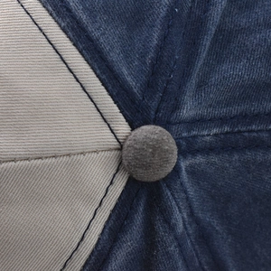 Detailed close-up of the washed cotton baseball cap crown with contrast stitching and button