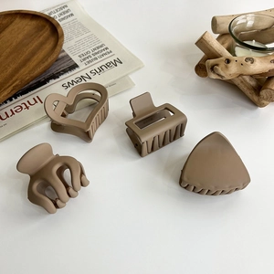 Elegant matte coffee-colored hair claws in four geometric shapes for a minimalist style