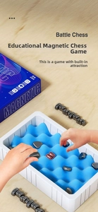Detailed view of children playing magnetic battle chess with pieces on blue foam board