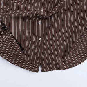 Women's brown and white striped lapel shirt with batwing sleeves and button detailing