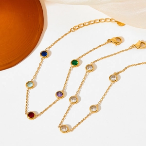 Elegant gold stainless steel bracelet with multi-colored round zircon stones on white silk