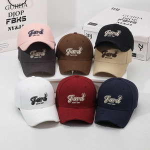 Distressed vintage baseball caps with 3D embroidery in multiple colors on white pedestals